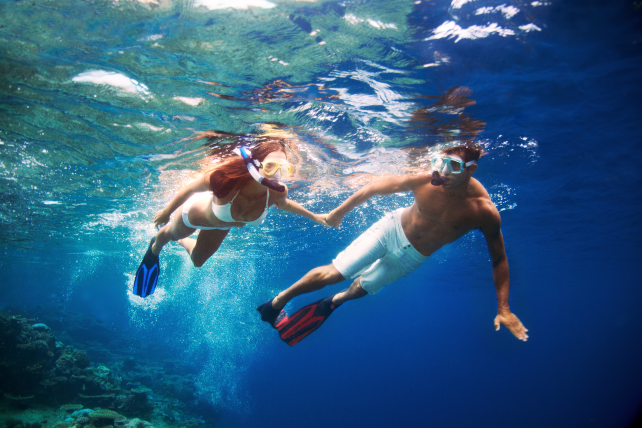A young couple enjoying snorkeling in the turquiose water of the sea