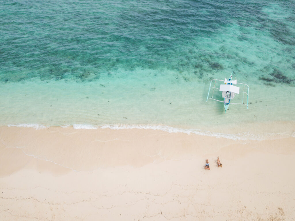 couple lying down in a sandbar after a boat tour in key west